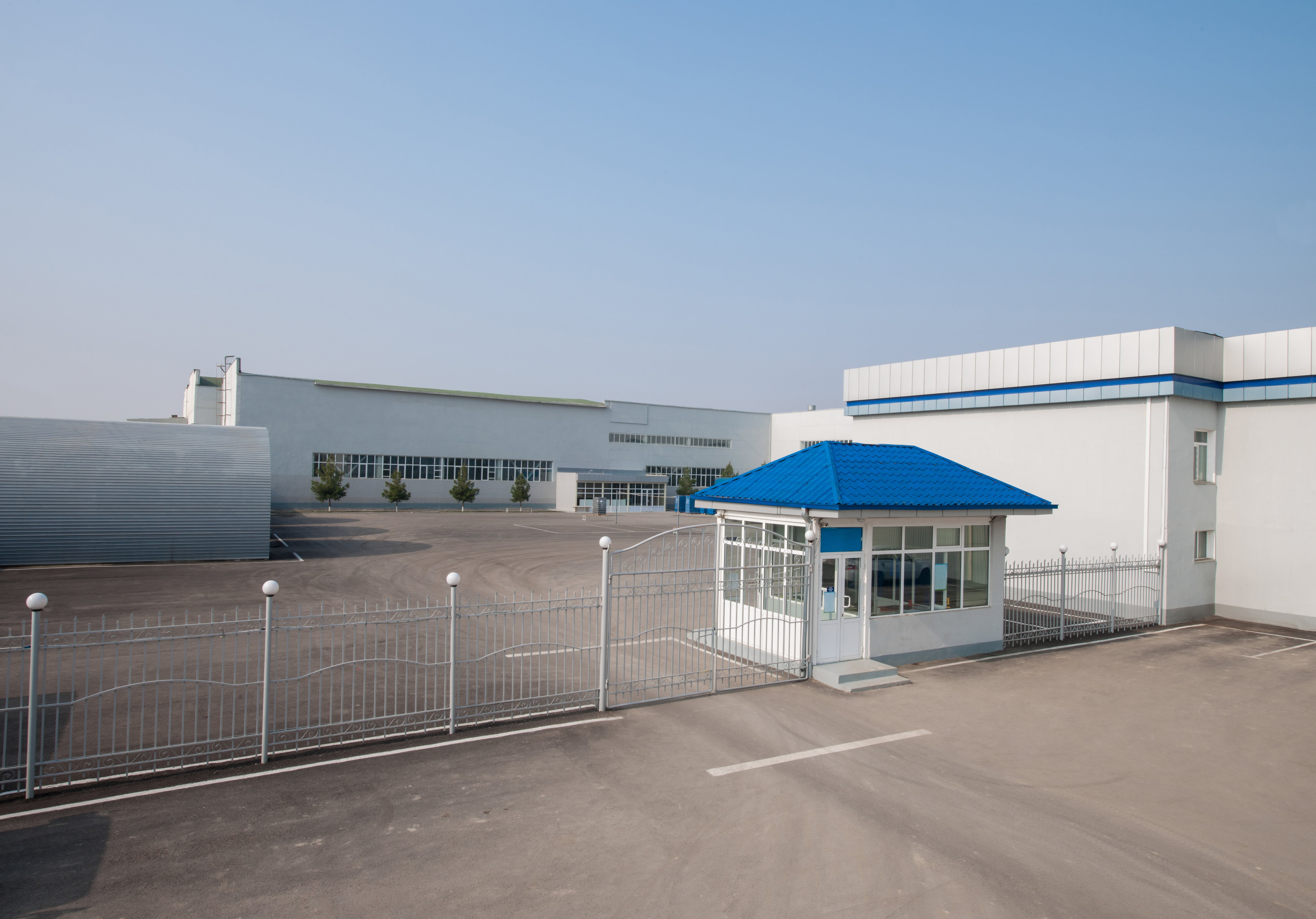 The outside of a facility showing security gates and fences