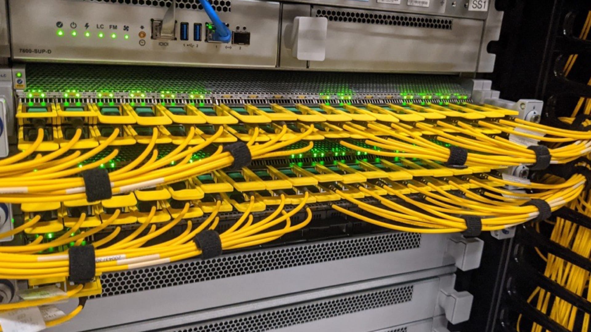 A series of yellow cables connected to data center equipment